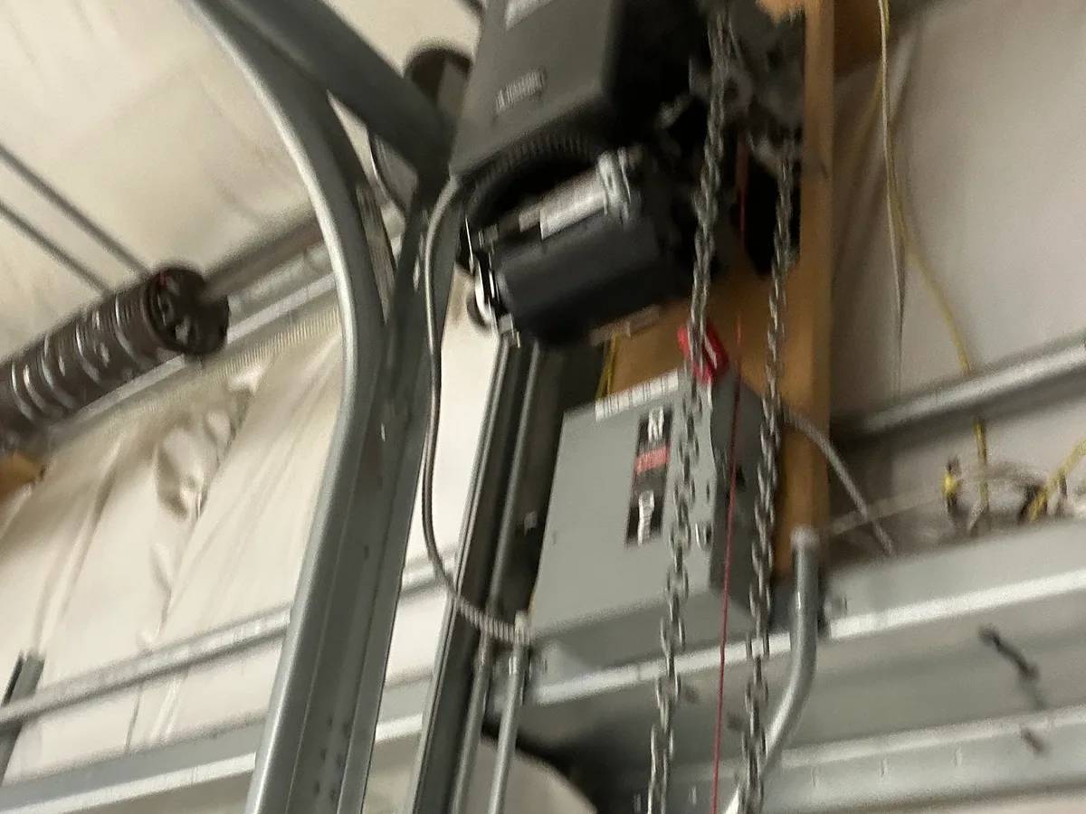 Garage door opener mounted to ceiling, ready for tune-up